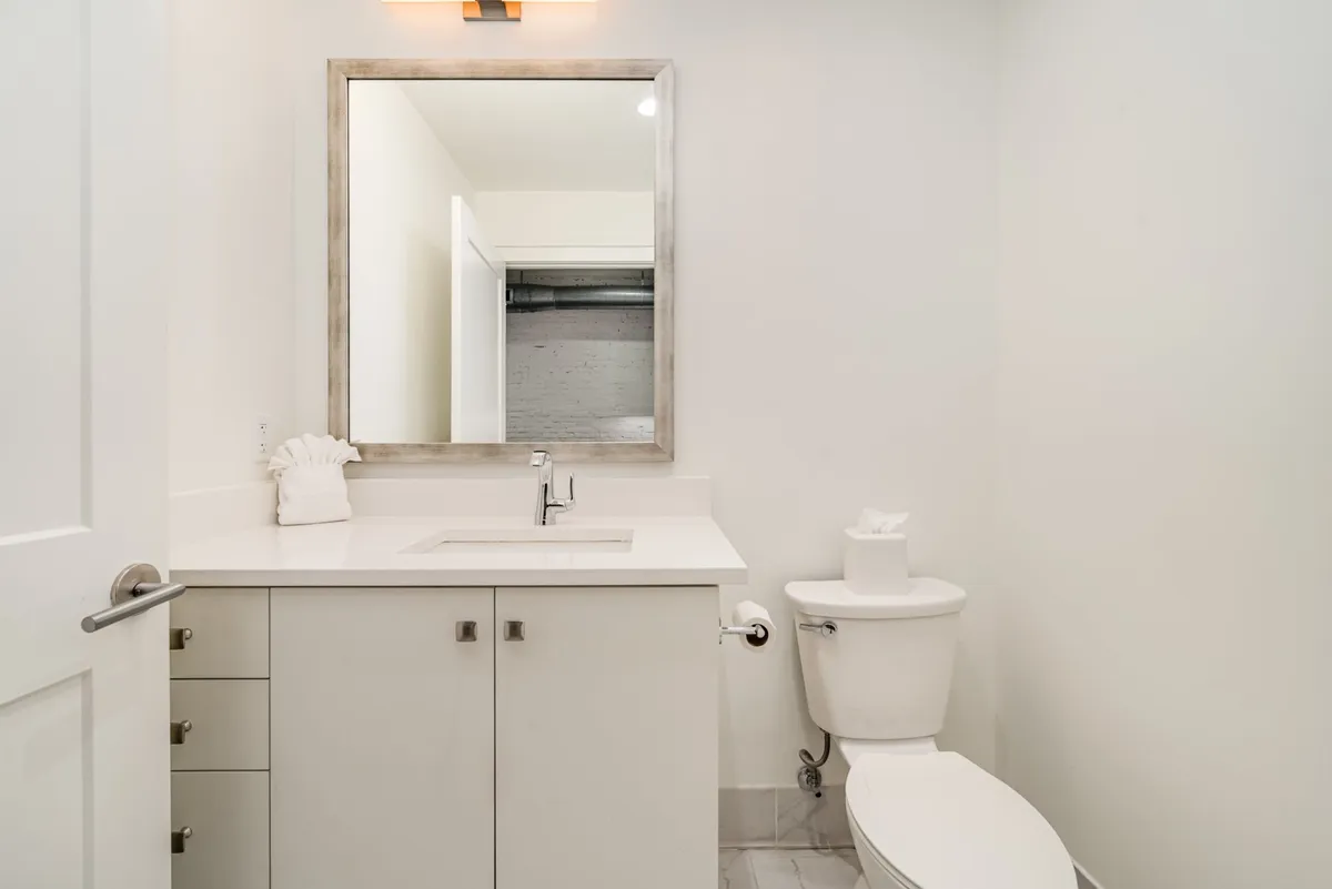 A soothing bathroom view focusing on a mirror, sink, and vanity. The calm decor creates an inviting setting for personal grooming and relaxation.