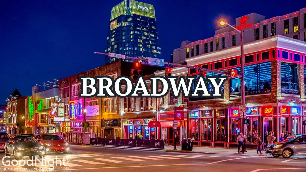 A vibrant nighttime street scene featuring colorful neon signs, bustling crowds, and a row of nightlife establishments. The energy is palpable, with people enjoying live music, dining outdoors, and exploring the lively urban environment.