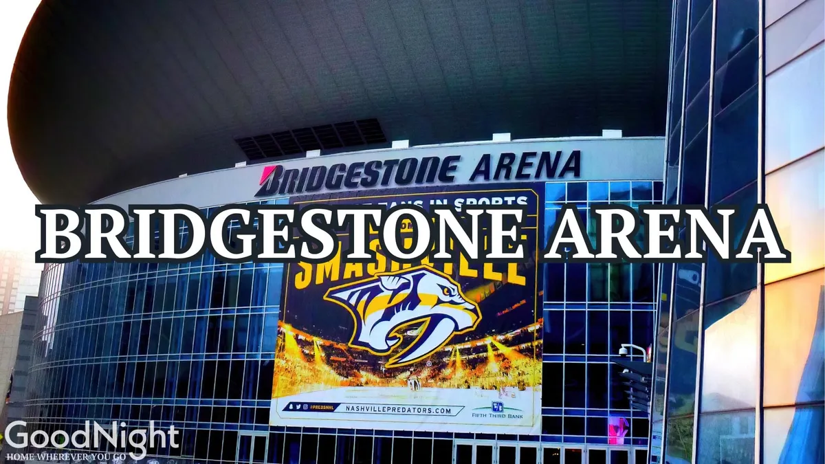 The exterior of Bridgestone Arena glows with the excitement of upcoming events. The prominent signage and banners set against striking modern architecture evoke the buzz of Nashville’s renowned entertainment district.